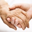 adult helping senior in hospital adult helping senior in hospital