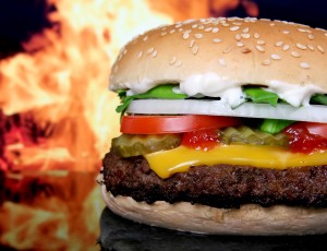 Silhouette of cheese burger and summer garden vegetables