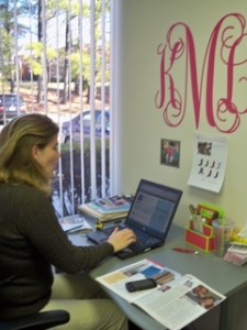 K & K Designs Co-Owner Kristin Melton in front of her sassy wall applique. Yeah, it's that cute.