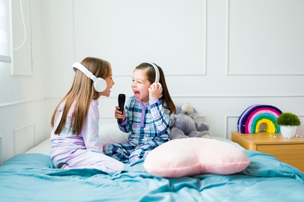 Happy,Little,Girls,Looking,Excited,While,Playing,Karaoke,And,Singing