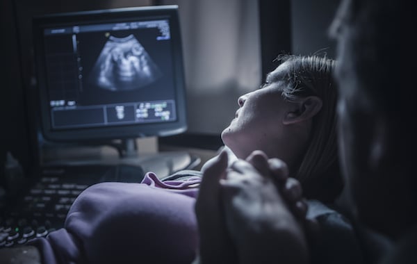 Pregnant couple having sonogram