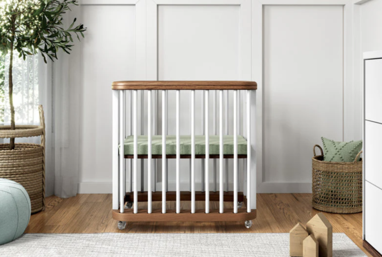 A baby crib in a room with white walls.