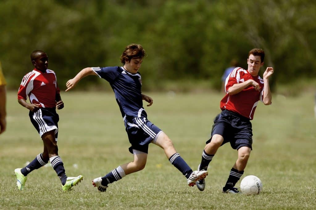 Teens playing soccer