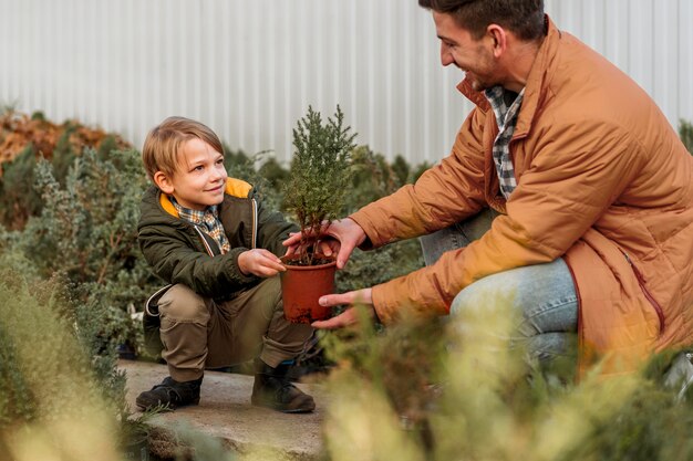Father and son at a tree nursery together