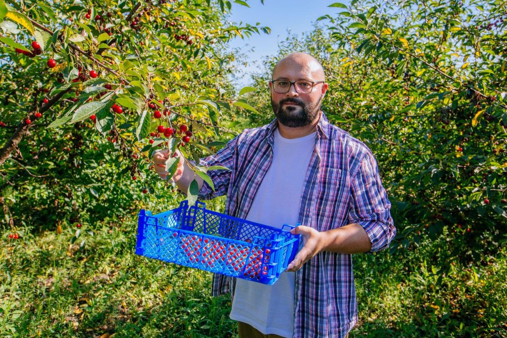 A man learning how to grow a cherry tree from seed.